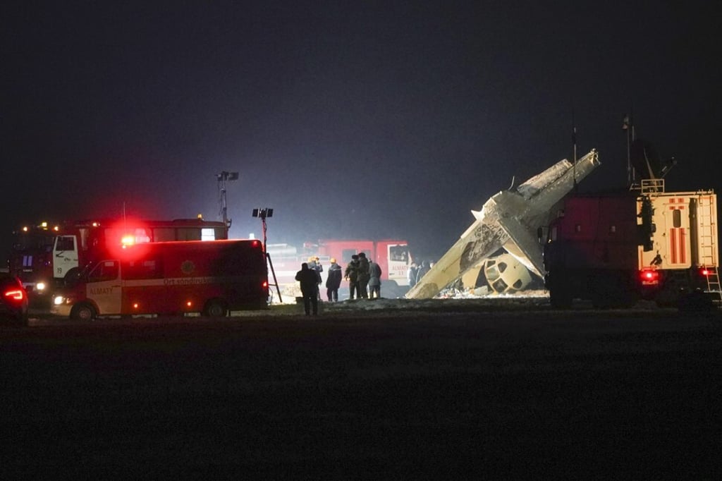 Emergency employees work at the side of the crashed Soviet-built An-26 two-engine turboprop at the airport of Almaty, Kazakhstan' on Saturday. Photo: AP