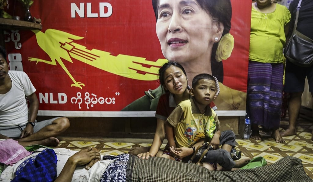 Ma Zin Mar Win, centre, cries next to the body of Thet Wai, aka Zaw Gyee, 35, who was shot dead while dragging an injured girl during a protest against the military coup in the Hlaing Tharyar district of Yangon. Photo: EPA-EFE Ma Zin Mar Win, centre, cries next to the body of Thet Wai, aka Zaw Gyee, 35, who was shot dead while dragging an injured girl during a protest against the military coup in the Hlaing Tharyar district of Yangon. Photo: EPA-EFE