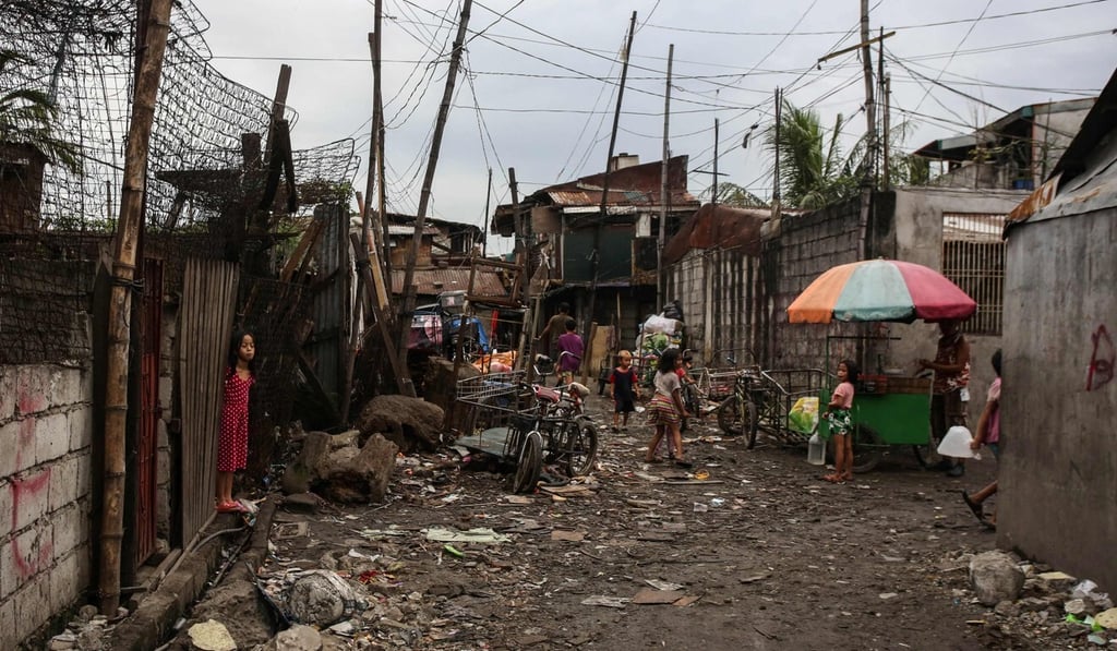 Children play in an alley at an informal settlers area in Malabon City, suburban Manila. Most students in the Philippines do not have a computer or internet at home. Photo: AFP Children play in an alley at an informal settlers area in Malabon City, suburban Manila. Most students in the Philippines do not have a computer or internet at home. Photo: AFP