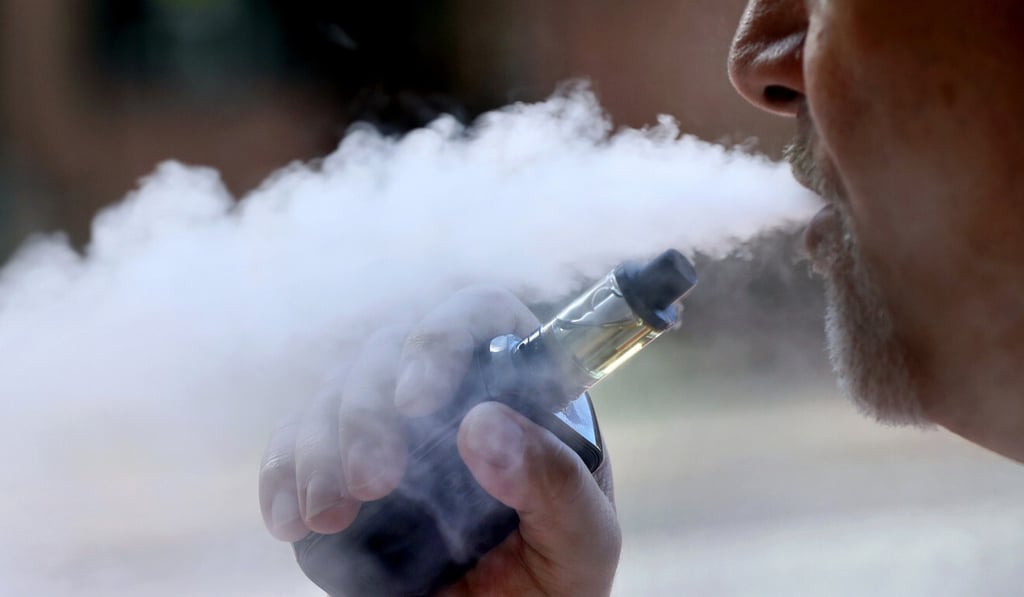 A man exhales while smoking an e-cigarette in Portland, Maine, in August 2019. Photo: AP
