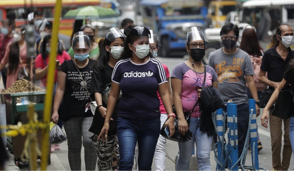 Commuters in Manila wear face masks and shields to help prevent the spread of the coronavirus. Photo: AP