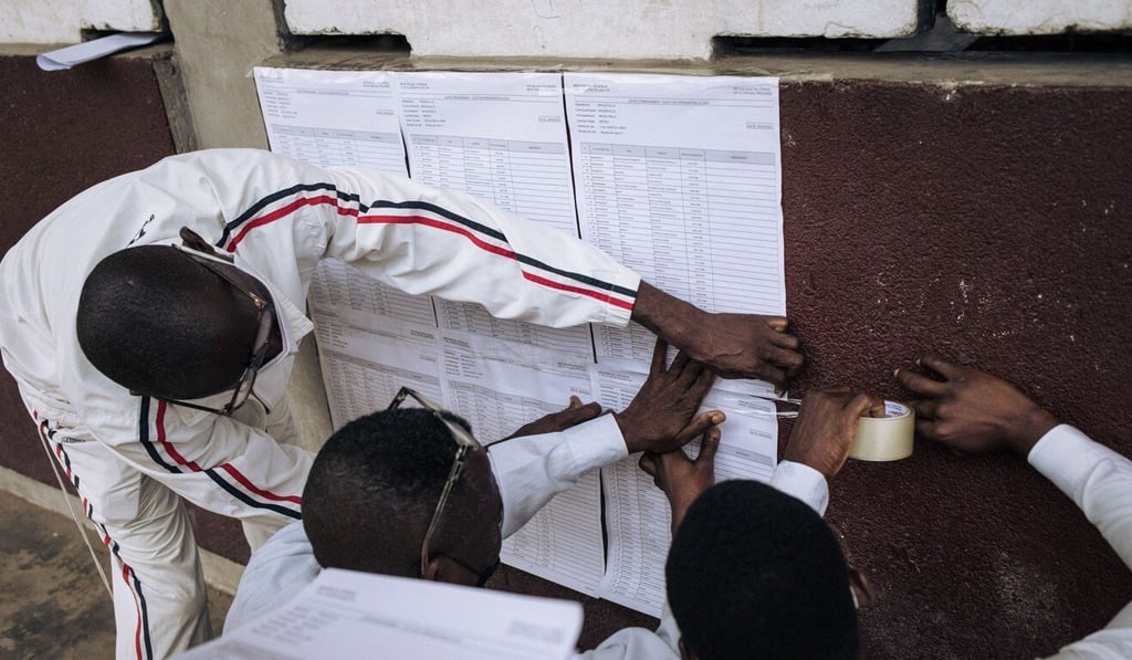 The voters roll is stuck on the wall at a polling station in Brazzaville, Congo, on Sunday. Photo: AFP