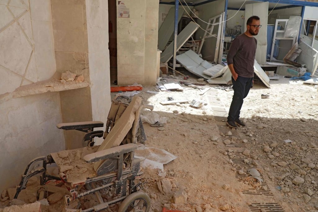 A man stands amid the debris at the entrance of a field hospital in the village of Atareb in the northern Syrian province of Aleppo on Sunday. Photo: AFP A man stands amid the debris at the entrance of a field hospital in the village of Atareb in the northern Syrian province of Aleppo on Sunday. Photo: AFP