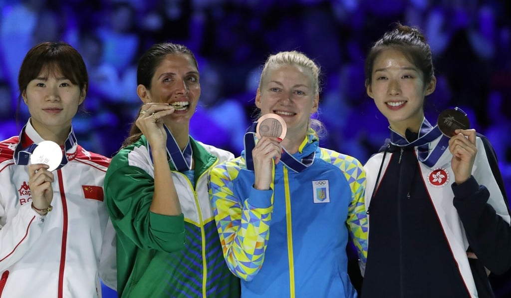 Vivian Kong (right) celebrates on the podium after winning the individual épée bronze at the 2019 World Championships in Budapest. Photo: AFP
