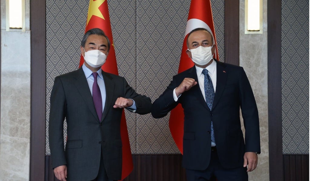 Chinese Foreign Minister Wang Yi bumps elbows with his Turkish counterpart, Mevlut Cavusoglu. Photo: EPA-EFE Photo: Xinhua