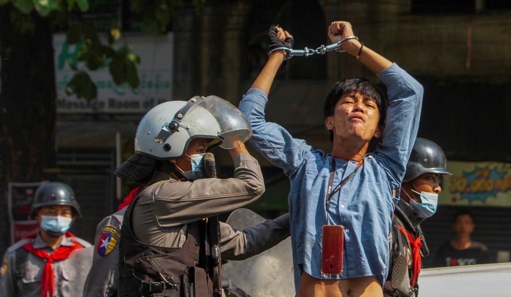 A pro-democracy protester is detained by riot police officers during a rally against the military coup in Yangon, Myanmar, in February. Photo: Reuters