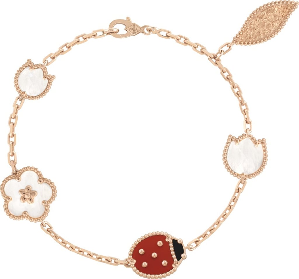 The ladybug motif has a rose-gold beaded framework inset with bright red-orange carnelian and deep black onyx, while white mother-of-pearl is used for the flower motifs. Photo: Van Cleef & Arpels The ladybug motif has a rose-gold beaded framework inset with bright red-orange carnelian and deep black onyx, while white mother-of-pearl is used for the flower motifs. Photo: Van Cleef & Arpels