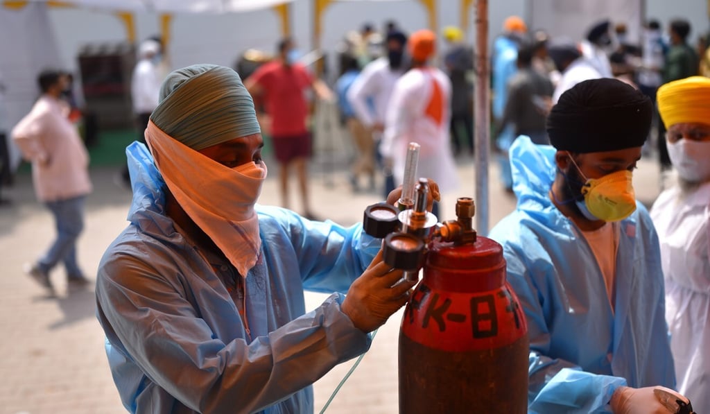 A man refilling the oxygen supply on Saturday at a Sikh shrine, or gurdwara, where oxygen is made available for free by various Sikh religious organizations in New Delhi, India. Photo: EPA-EFE