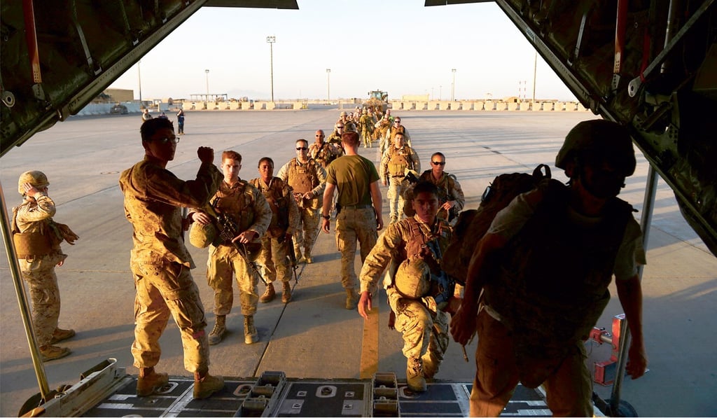 US Marine soldiers enter an aeroplane as British and US troops withdraw from the Camp Bastion-Leatherneck complex at Lashkar Gah in Helmand province in October 2014. Photo: AFP