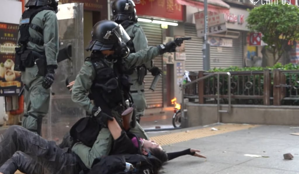 Police subdue a protester. The violence in Tsuen Wan on National Day of 2019 marked one of the grimmest episodes of the civil unrest that year. Photo: Campus TV, HKUSU Police subdue a protester. The violence in Tsuen Wan on National Day of 2019 marked one of the grimmest episodes of the civil unrest that year. Photo: Campus TV, HKUSU