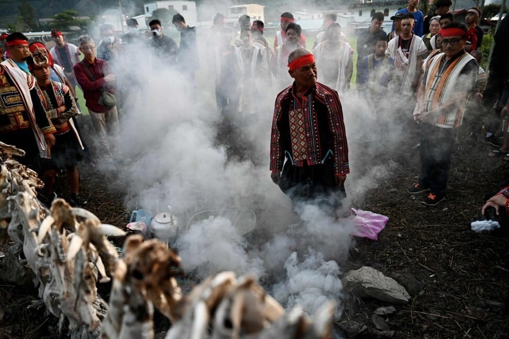 An indigenous priest stands at the centre of a group of clansmen during a festival in Taiwan’s Taitung county. Photo: AFP An indigenous priest stands at the centre of a group of clansmen during a festival in Taiwan’s Taitung county. Photo: AFP