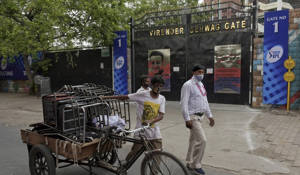 A worker carries chairs on a rickshaw after dismantling a temporary security installation outside Arun Jaitley Stadium, one of the six venues of Indian Premier League 2021 in New Delhi. Photo: AP A worker carries chairs on a rickshaw after dismantling a temporary security installation outside Arun Jaitley Stadium, one of the six venues of Indian Premier League 2021 in New Delhi. Photo: AP