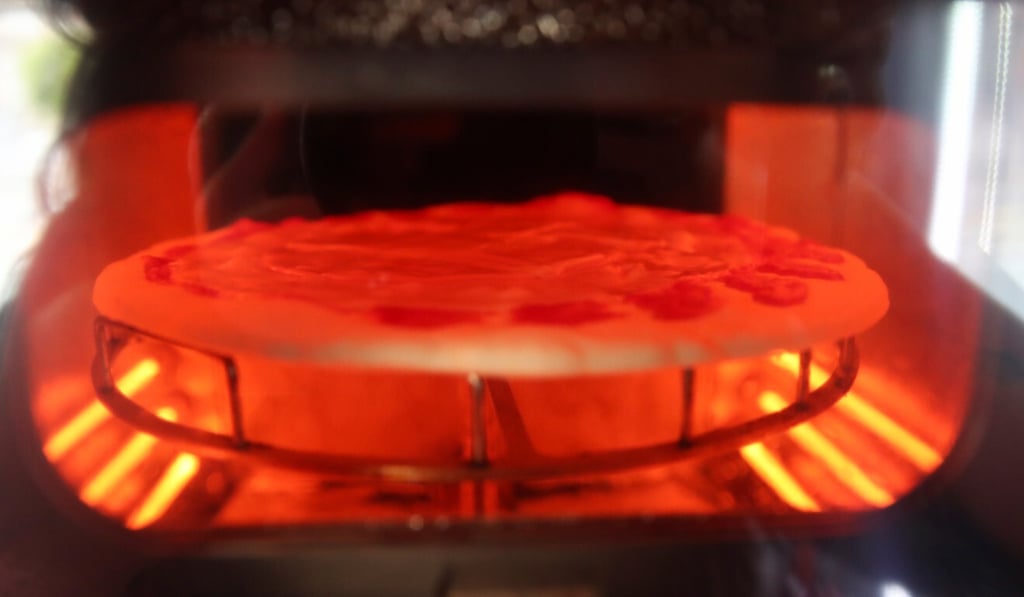 The machine is capable of kneading, seasoning and cooking the pizza in three minutes. Photo: Reuters