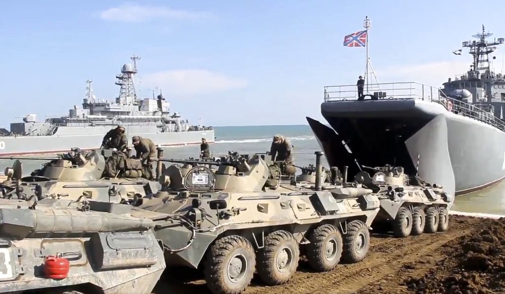The Russian military's armored vehicles roll into landing vessels after drills in Crimea on April 23. Russian Defence Minister Sergei Shoigu on Thursday ordered troops back to their permanent bases after a massive military buildup. Photo: Russian Defense Ministry Press Service via AP