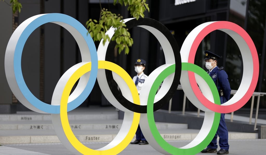 Police officers wearing protective masks stand by the Olympic rings near National Stadium, the main site for the Tokyo 2020 Olympic Games. Photo: Bloomberg Police officers wearing protective masks stand by the Olympic rings near National Stadium, the main site for the Tokyo 2020 Olympic Games. Photo: Bloomberg