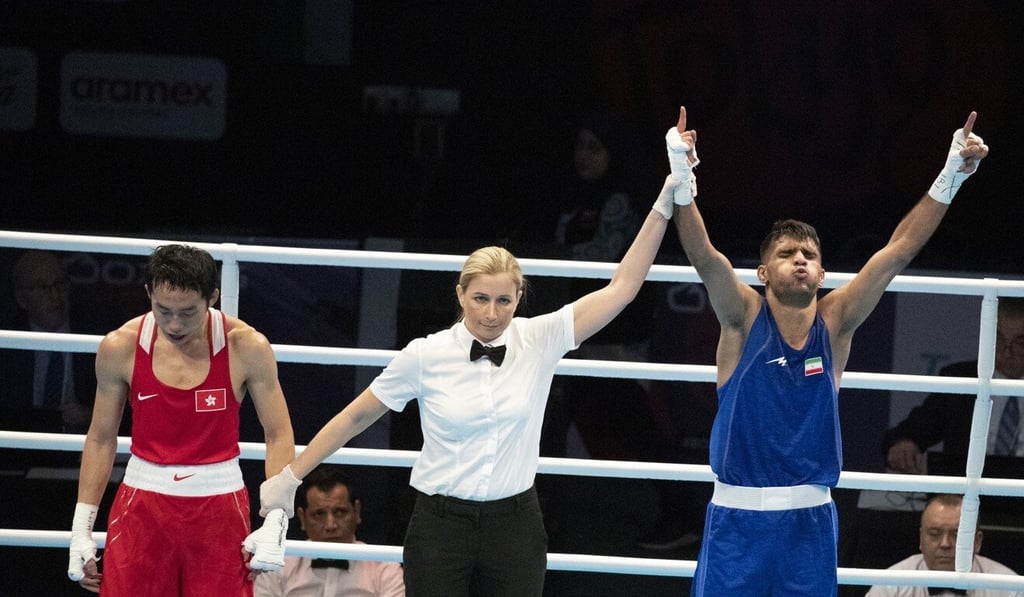 Rex Tso is beaten by Iranian Daniyal Shabakhsh (blue) at the Tokyo 2020 Olympic Boxing qualification tournament in Amman, Jordan. Photo: EPA-EFE