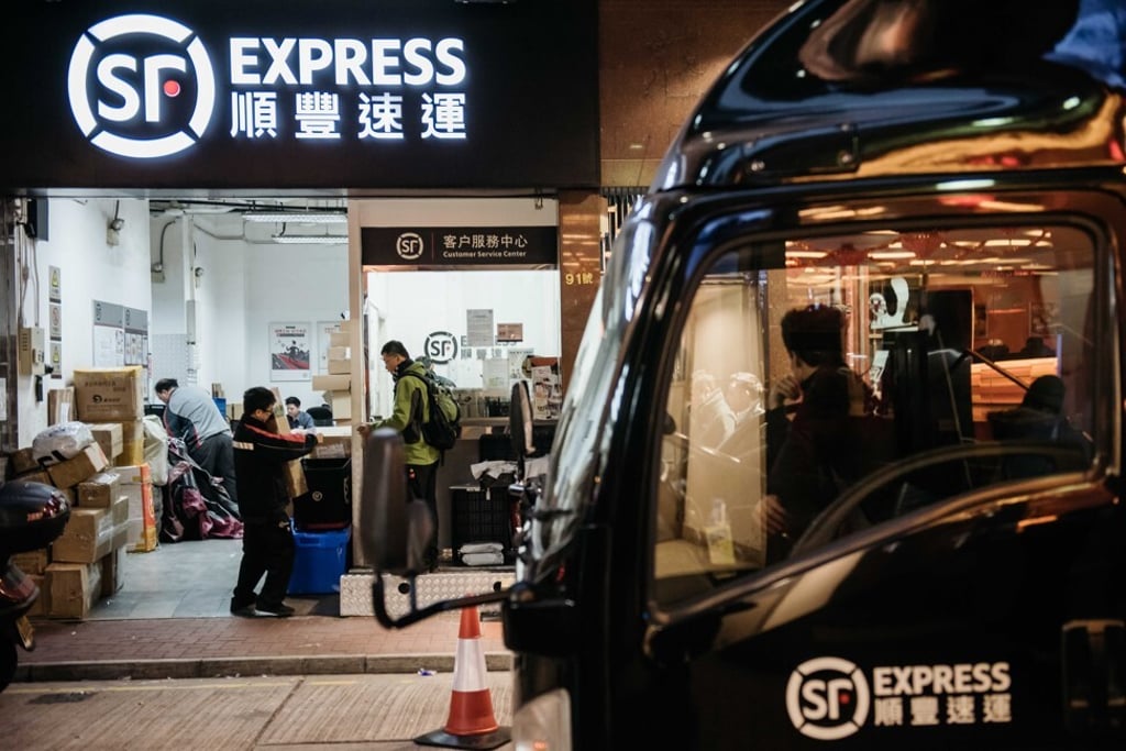 Employees handle packages at an SF Express store in Hong Kong. Source: Bloomberg