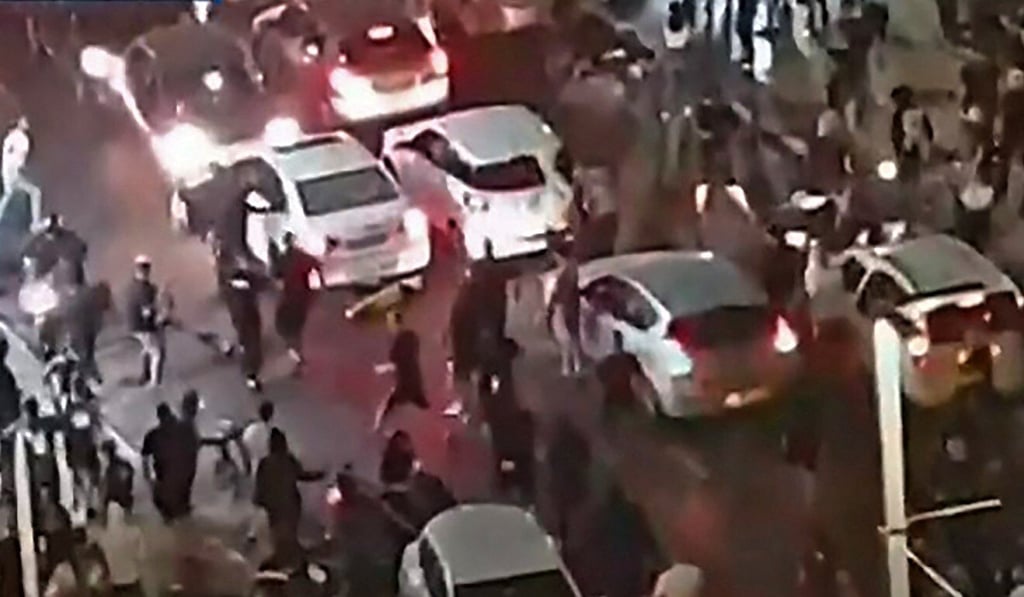 Television footage shows an Israeli mob attacking a person they considered an Arab man on the seafront promenade of Bat Yam, a town south of Israel‘s commercial capital Tel Aviv. Photo: Kan 11 public broadcaster via AFP Television footage shows an Israeli mob attacking a person they considered an Arab man on the seafront promenade of Bat Yam, a town south of Israel‘s commercial capital Tel Aviv. Photo: Kan 11 public broadcaster via AFP