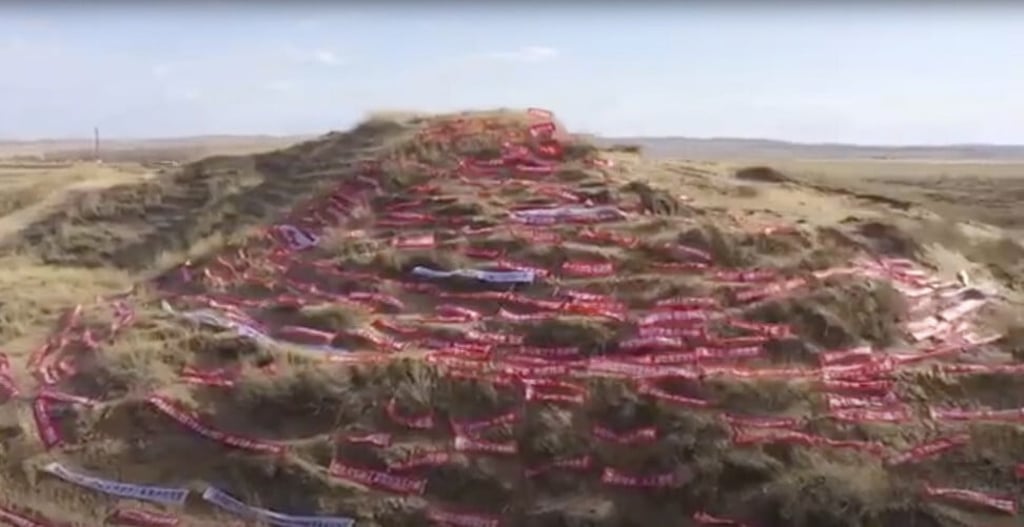 The artists enlisted volunteers to help erect the banners on a hillside at a secret location in Northern China. Photo: Handout
