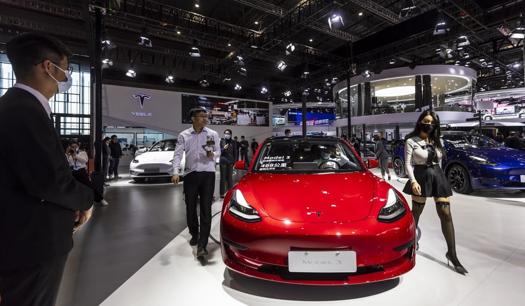 People walk by a Tesla Model 3 car during a media preview of the Shanghai Auto Show on April 19, 2021. Photo: EPA-EFE People walk by a Tesla Model 3 car during a media preview of the Shanghai Auto Show on April 19, 2021. Photo: EPA-EFE