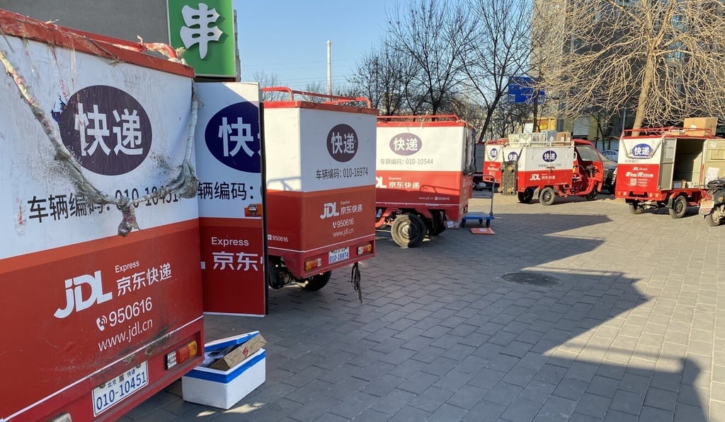 Delivery trucks are parked outside a JD Logistics delivery station in Chaoyang district in Beijing, China, on February 26, 2021. Photo: Minghe Hu