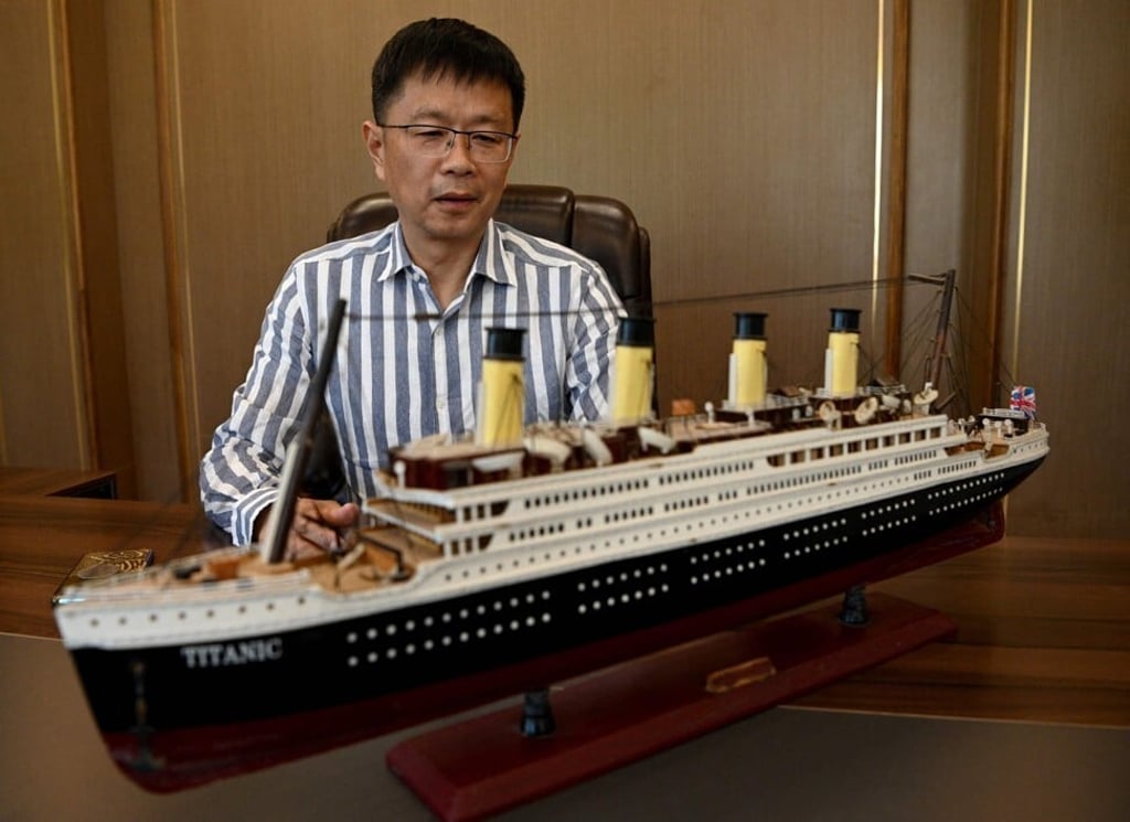 Investor Su Shaojun is pictured with a model of the ship during an interview at his office in Daying County. Photo: AFP