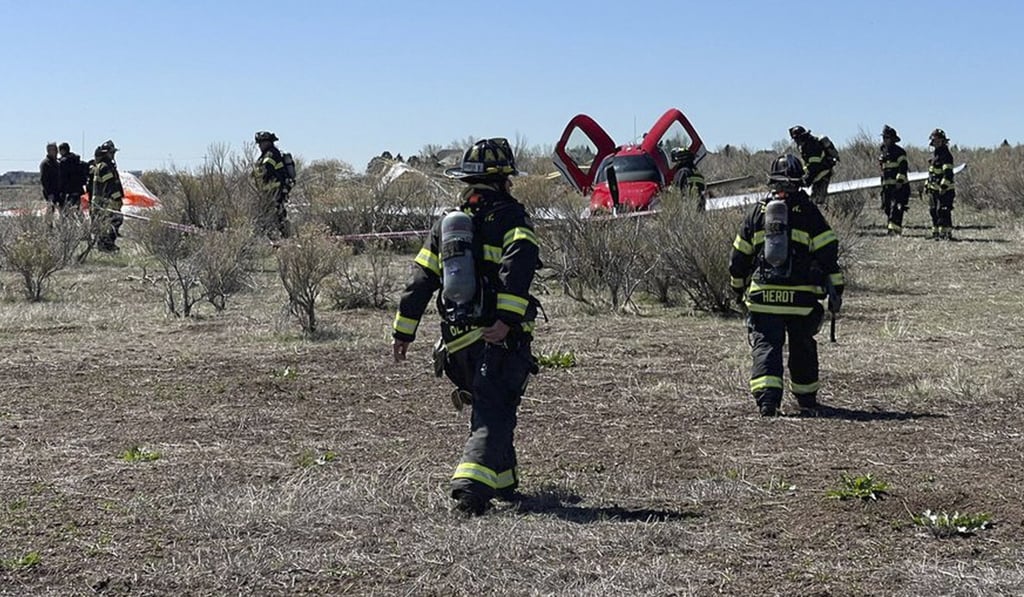 Emergency personnel work at the scene where a single-engine plane landed after a mid-air collision near Denver on Wednesday. Photo: South Metro Fire Rescue via AP Emergency personnel work at the scene where a single-engine plane landed after a mid-air collision near Denver on Wednesday. Photo: South Metro Fire Rescue via AP