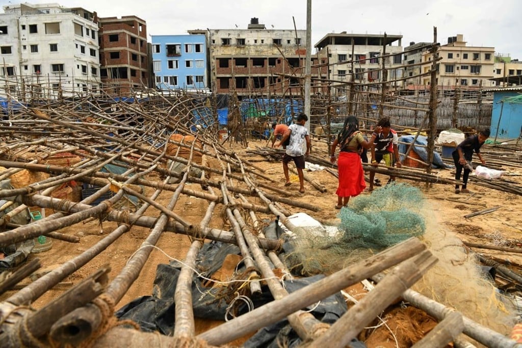 Fisherfolk mend bamboo racks used to dry fishes after they were brought down by strong winds ahead of Cyclone Tauktae’s landfall. Photo: AFP Fisherfolk mend bamboo racks used to dry fishes after they were brought down by strong winds ahead of Cyclone Tauktae’s landfall. Photo: AFP