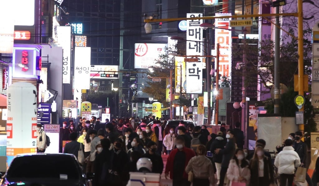 Pedestrians near Gangnam Station in southern Seoul, South Korea. The area is home to many night clubs, bars and red-light businesses. Photo: EPA