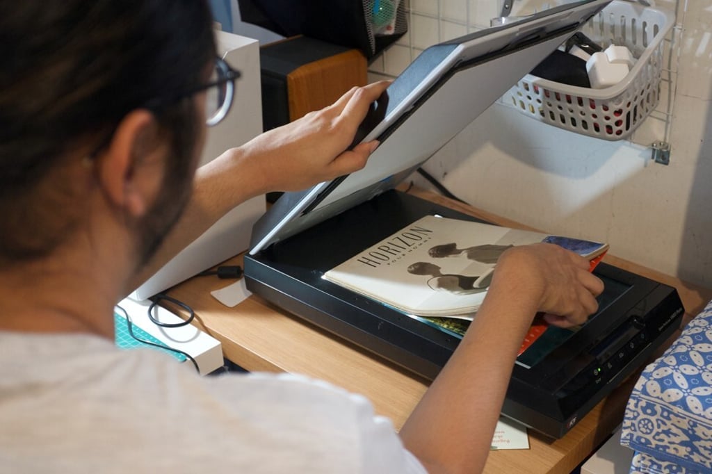 Ais scans an LGBTQ magazine while digitising it in Jakarta. Photo: Handout via Reuters Ais scans an LGBTQ magazine while digitising it in Jakarta. Photo: Handout via Reuters