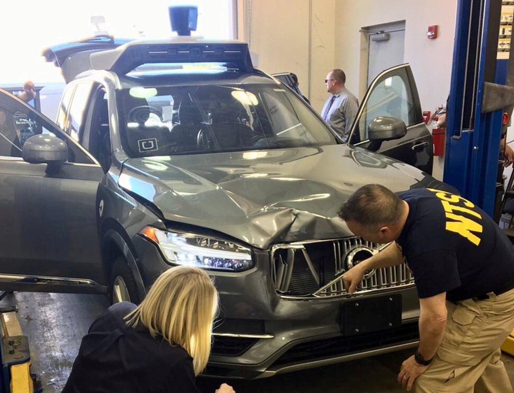 US National Transportation Safety Board investigators examine a self-driving Uber Technologies vehicle involved in a fatal accident in Tempe, Arizona, on March 20, 2018. Photo: Reuters US National Transportation Safety Board investigators examine a self-driving Uber Technologies vehicle involved in a fatal accident in Tempe, Arizona, on March 20, 2018. Photo: Reuters