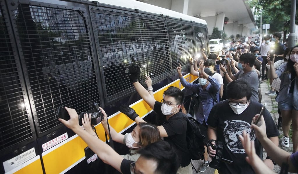 Supporters of Tong Ying-kit alongside the bus transporting him from West Kowloon Court in October. Tong is the first person charged and remanded under Hong Kong’s new national security law. Photo: SCMP / Winson Wong