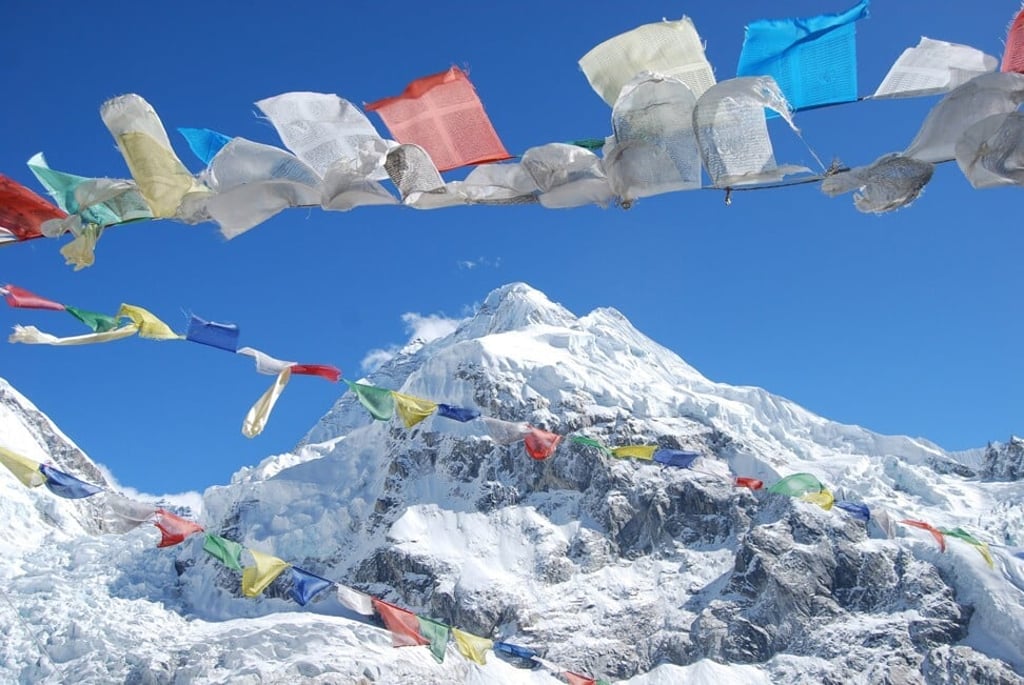 Prayer flags flutter in the breeze at Mount Everest. Photo: Dreamstime / TNS