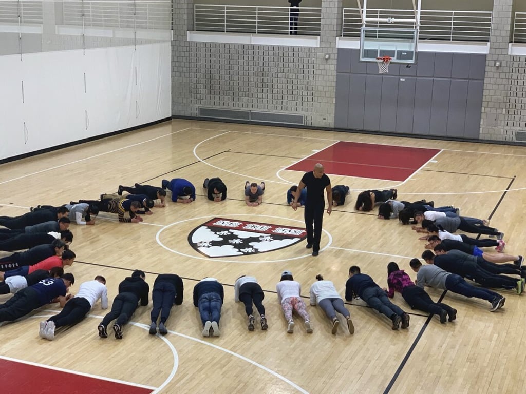 Nicholson teaching students how to plank in Beijing. Photo: Courtesy of Tony Nicholson