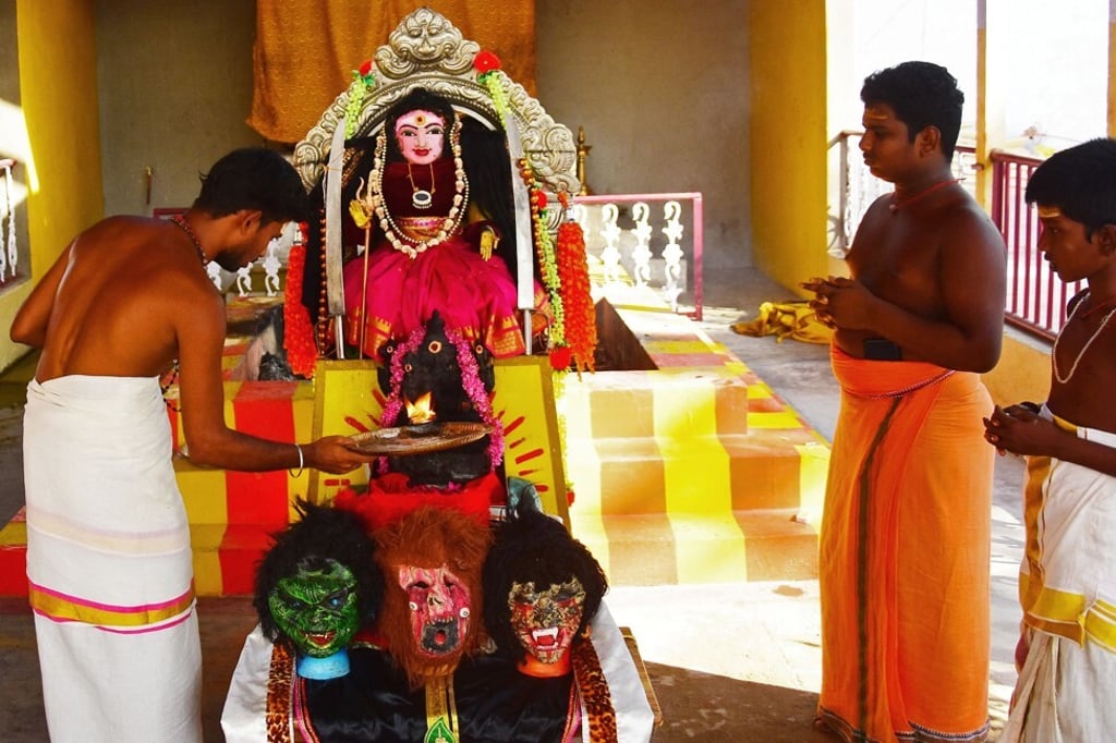 Hindus perform a prayer ritual in front of an idol locally known as ‘Corona Devi’. Photo: AFP Hindus perform a prayer ritual in front of an idol locally known as ‘Corona Devi’. Photo: AFP