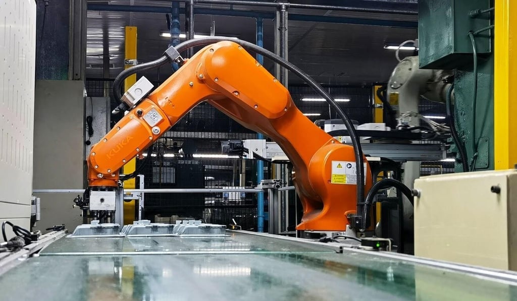 In Midea’s microwave factory, orange robotic arms are welding and assembling parts. Photo: Handout