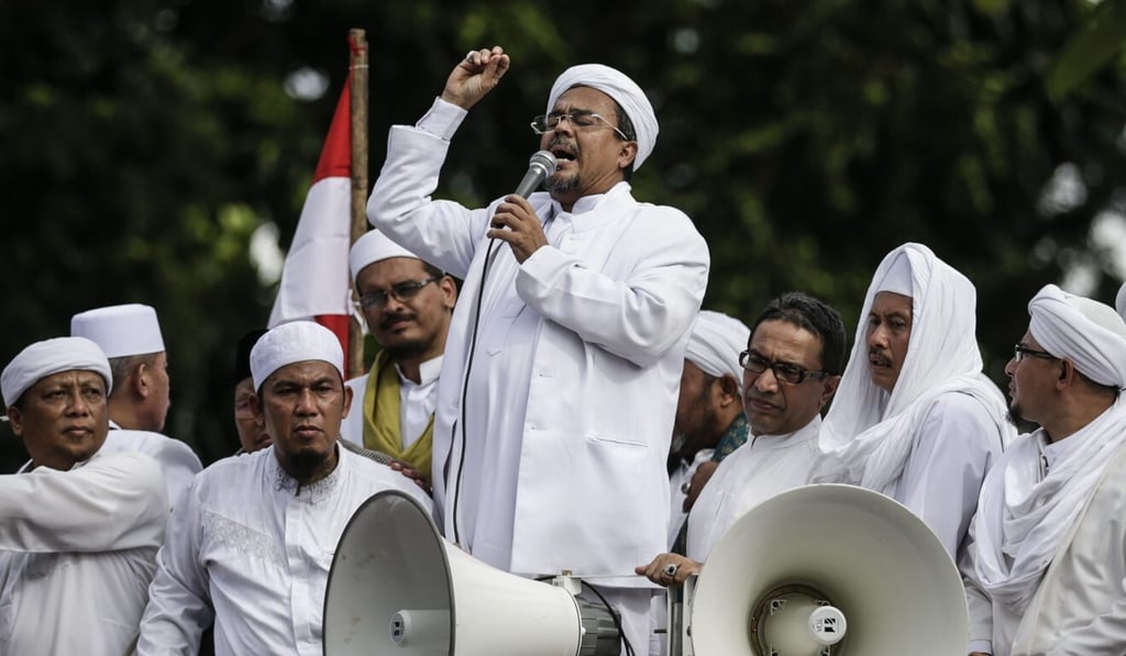 Habib Rizieq Shihab, the leader of the Islamic Defenders Front, speaks to supporters outside the police headquarters in Jakarta, Indonesia in 2017. Photo: EPA