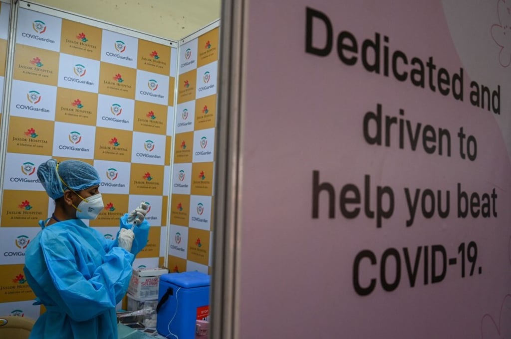 A health worker prepares a dose of the Covishield vaccine for use at a vaccination centre in Mumbai on May 26. The US in April removed impediments to the export of raw materials for vaccines. Photo: AFP