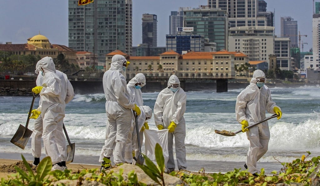Sri Lankan Navy personnel remove debris washed ashore from the blaze on the Singapore-registered container ship MV X-Press Pearl. Photo: AFP