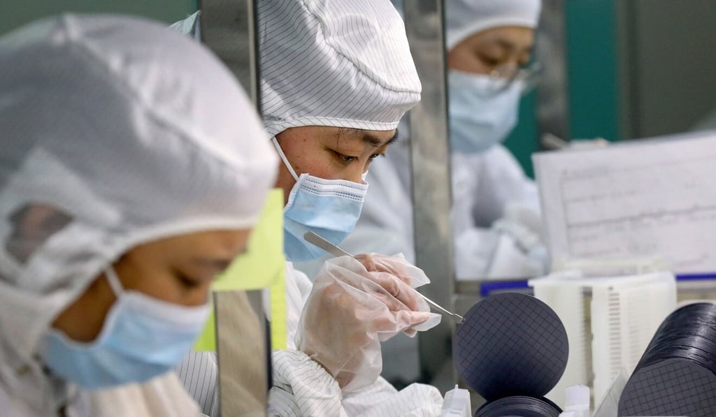 Employees make semiconductor chips in a factory in China. Photo: STR via AFP Employees make semiconductor chips in a factory in China. Photo: STR via AFP