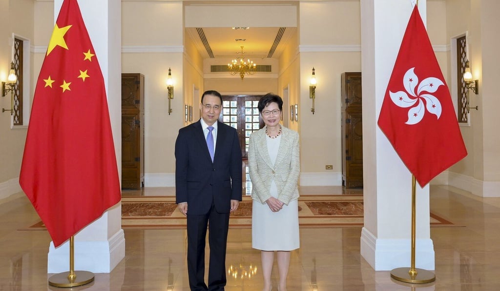 Liu Guangyuan, new head of the Chinese foreign ministry’s Hong Kong office, poses with city leader Carrie Lam after their first meeting on Tuesday. Photo: Handout