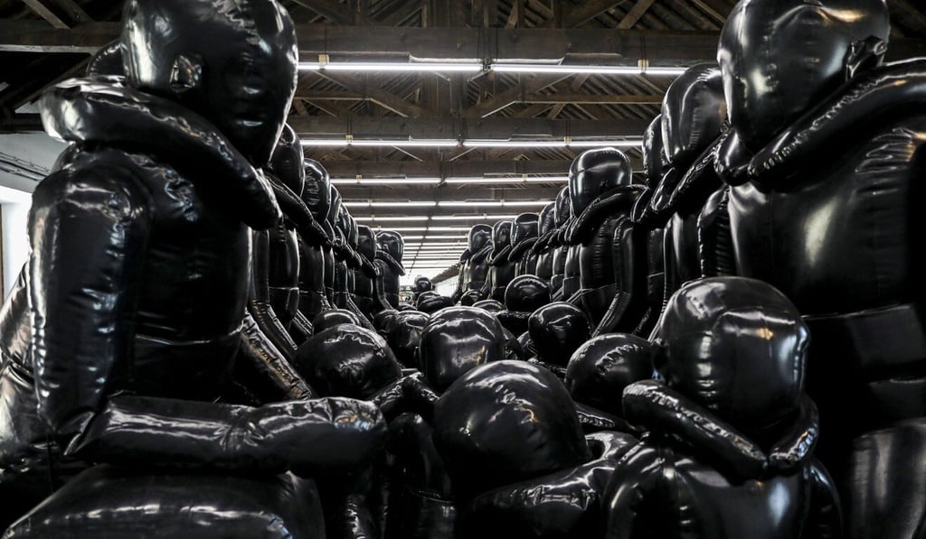An installation titled 'Law of the Journey' by Chinese contemporary artist Ai Weiwei, showing an inflatable boat with faceless refugee figures, is on display in his first exhibition in Portugal. Photo: EPA-EFE An installation titled 'Law of the Journey' by Chinese contemporary artist Ai Weiwei, showing an inflatable boat with faceless refugee figures, is on display in his first exhibition in Portugal. Photo: EPA-EFE