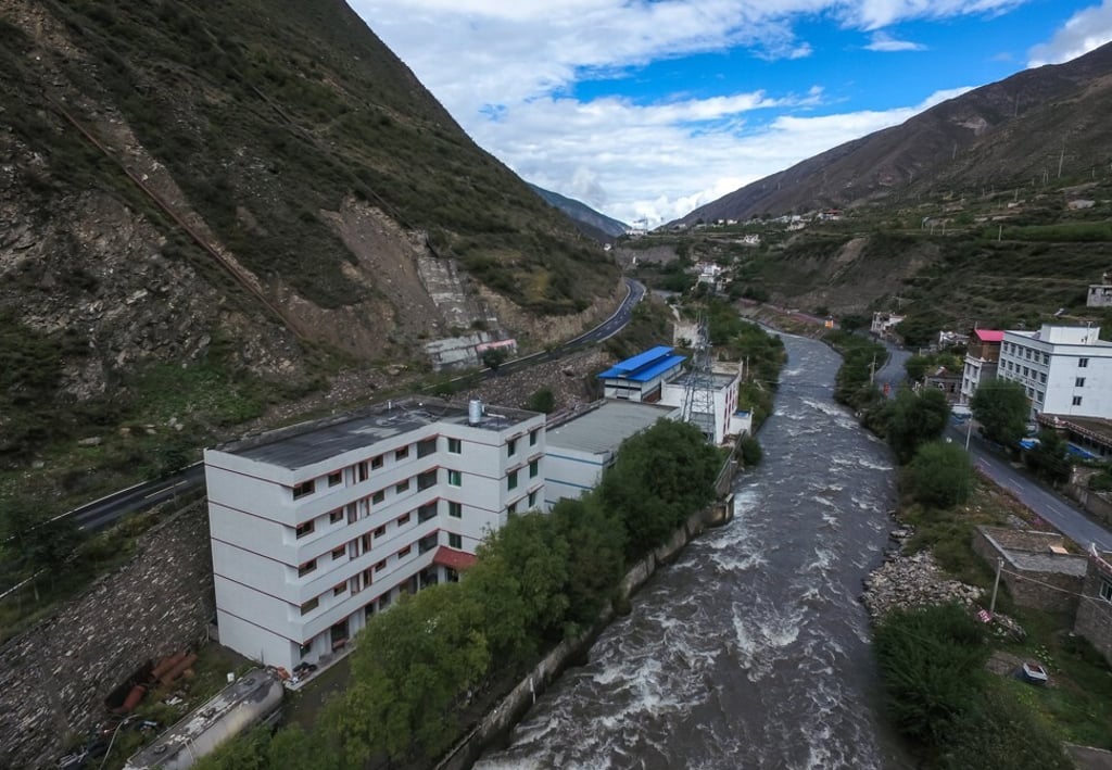 A bitcoin “mine” with a blue tin roof sits next to a hydroelectric power plant in Ngawa (Aba) Tibetan and Qiang Autonomous Prefecture, Sichuan province, on September 27, 2016. Beijing is cracking down on energy-intensive mining activities, but Sichuan could let the booming industry take advantage of excess hydropower over the summer. Photo: EPA