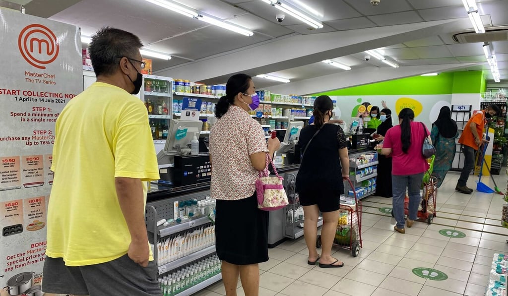 People observe social distancing at a supermarket in Singapore. Photo: AP People observe social distancing at a supermarket in Singapore. Photo: AP