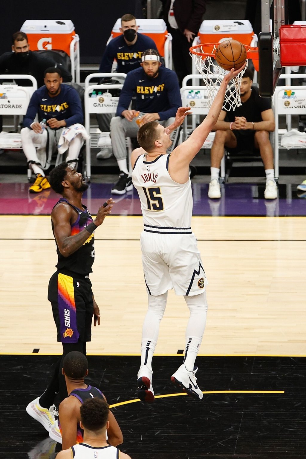 Nikola Jokic of the Denver Nuggets lays up a shot past Deandre Ayton of the Phoenix Suns in the first half of their Western Conference second-round play-off series at the Phoenix Suns Arena. Photo: AFP