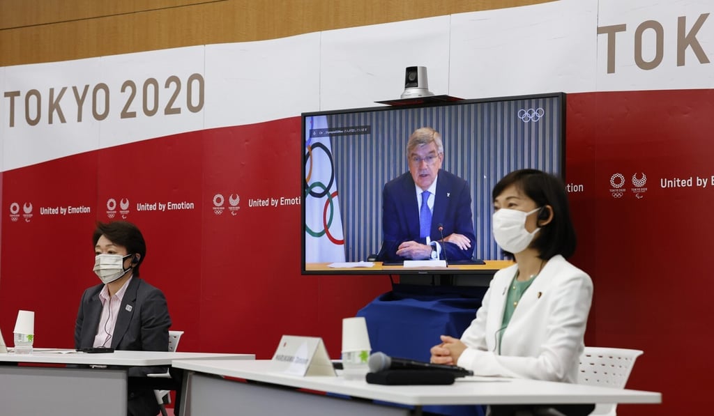 Tokyo 2020 organising committee president Seiko Hashimoto (left) Japanese Olympic minister Tamayo Marukawa (right) and IOC president Thomas Bach, on a screen, attend a five-party online meeting at Harumi Island Triton Square Tower Y in Tokyo. Photo: AP