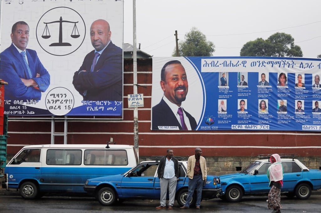 Taxi drivers stand in front of campaign banners of the Ethiopian Prime Minister Abiy Ahmed, and Birhanu Nega, head of the Ethiopian Citizens for Social Justice party, in Addis Ababa, Ethiopia on Sunday. Photo: Reuters