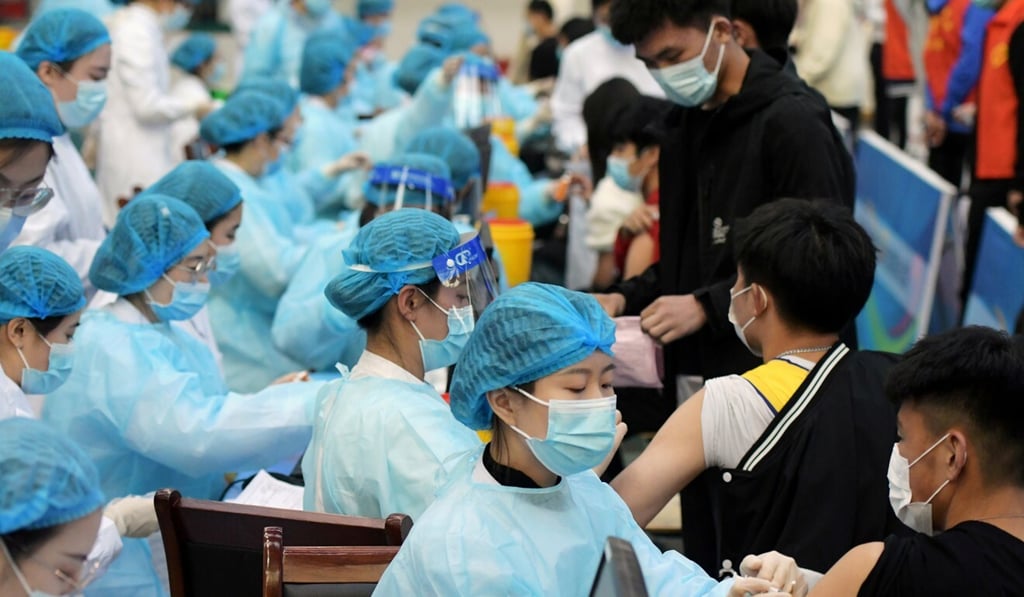 Medical workers inoculate students against Covid-19. Photo: Reuters Medical workers inoculate students against Covid-19. Photo: Reuters