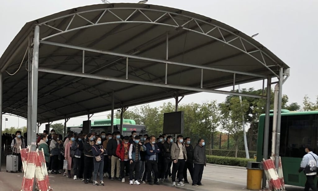 Outside one of Foxconn Technology Group’s recruitment centres in Zhengzhou, applicants who passed the interview process line up to be taken by bus to another site for physical examination. Photo: SCMP Outside one of Foxconn Technology Group’s recruitment centres in Zhengzhou, applicants who passed the interview process line up to be taken by bus to another site for physical examination. Photo: SCMP