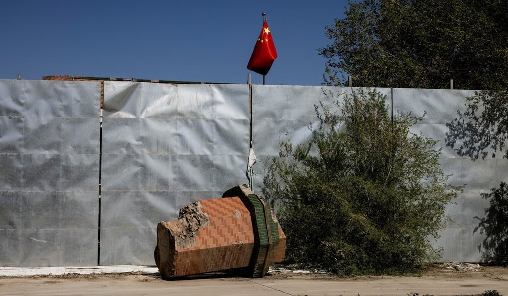 A broken-off minaret from the Xinqu Mosque lies near a Chinese national flag outside Urumqi, in the Xinjiang Uygur autonomous region, on May 6. Photo: Reuters